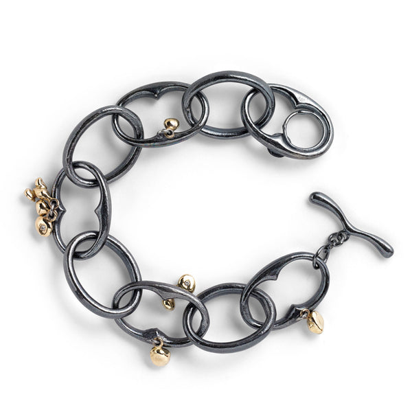The InsideOut bracelet features bold blackened sterling silver links accented with 18k yellow gold elements, adorned with small diamonds. This striking piece combines fashion and movement with a rock & roll edge, making it a standout accessory.  • Blackened sterling silver, 18k yellow gold, diamonds 0.06 cts
