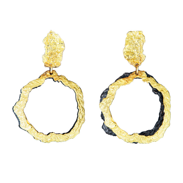 The That Place in Between earrings, crafted in 18k yellow gold and blackened sterling silver, exhibit a playful and artistic design. • 18k yellow gold, blackened sterling silver • Posts • Length: 1.5"
