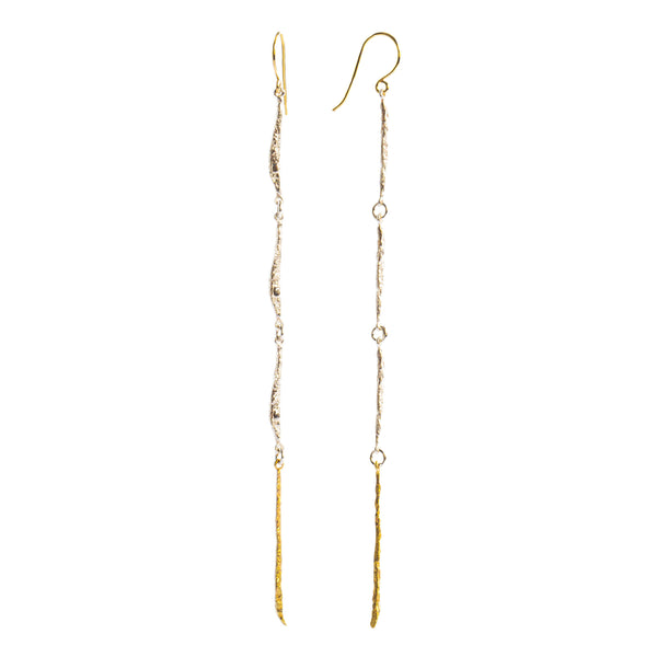 The Spark & Soul long earring features a fluid design, combining sterling silver and 18k yellow gold. This elegant piece makes a statement of femininity. • Blacked sterling silver, 18k yellow gold • Length: 3"