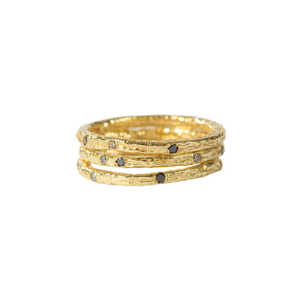 The Spark & Soul stacking ring in 18k yellow gold, accented with small white and black diamonds, is a playful design perfect for everyday wear. It adds a spark to your day with its charming and versatile style. • 18k yellow gold, diamonds 0.36 cts