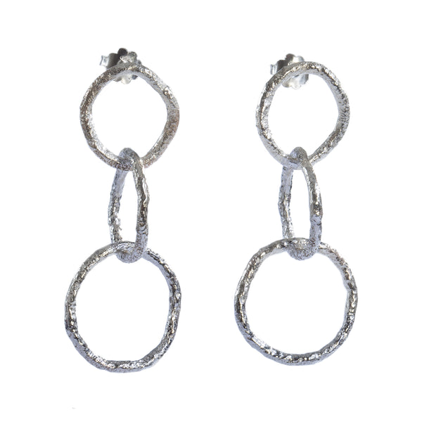 The Spark & Soul dangling earrings in sterling silver showcase simplicity with a touch of earthy and contemporary flair. • Sterling silver • Length: 2.25"