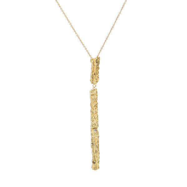 Raw You Long Gold Necklace by Emanuela Duca - The Raw You Collection's pendant necklace. Adorned with a petite diamond, its long textured pendant exudes sophistication and allure. A symbol of individuality and femininity, this design speaks volumes with its understated charm. Height: 3 inches.