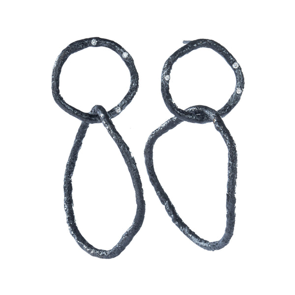 The Spark & Soul dangling earrings in blackened sterling silver showcase simplicity with a touch of earthy and contemporary flair. The top textured links are adorned with small diamonds, creating an effect reminiscent of a dark sky filled with stars. • Blackened sterling silver, diamonds 0.09 cts • Length: 2.25"