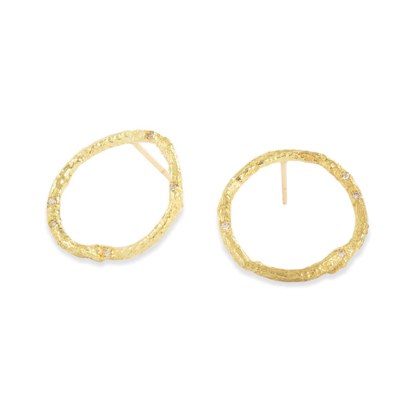These Svelare circle earrings, crafted in textured 18k yellow gold, serve as a delicate accent to your attire, adorned with tiny diamonds. • 18k yellow gold, diamonds ct: 0.07 • Post backs • Height: 0.75 inches