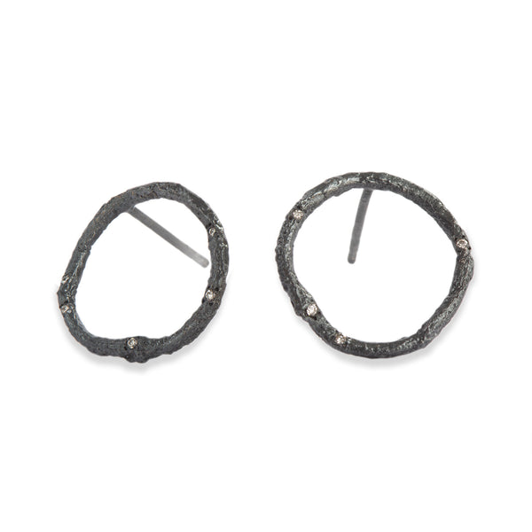 These Svelare circle earrings, crafted in textured blackened sterling silver, serve as a delicate accent to your attire, adorned with tiny diamonds. • Blackened sterling silver, diamonds ct: 0.08 • Post backs • Height: 0.75 inches
