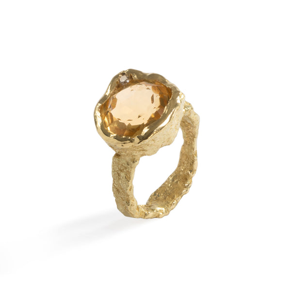 Colibri' Citrine Ring by Emanuela Duca - The Colibri' ring, crafted in textured 18k yellow gold, showcases a stunning 12mm citrine stone paired with a diamond (2mm). The warmth of the gold is complemented by the radiant yellow hue of the citrine, resembling a small sun. This piece adds a vital spark to your look, infusing it with energy and elegance. • Citrine, diamond, 18k yellow gold