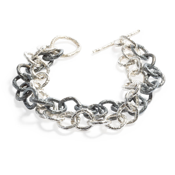 Good Vibes Black & White Bracelet by Emanuela Duca - A bold interplay of black and white textured sterling silver links. This captivating piece is defined by the stark contrast between the two lines of links, creating a visually stunning and versatile accessory.