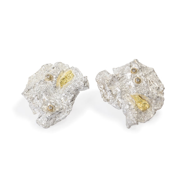 Raw You Silver Clips Earrings by Emanuela Duca - Introducing our sterling silver earrings, adorned with exquisite texture and a touch of gold. Featuring four dazzling 2mm diamonds, their captivating design adds flair and style to any outfit. With clips and posts for easy wear, these earrings are the perfect accessory to elevate your look with effortless elegance. Height: 1.25 inches.
