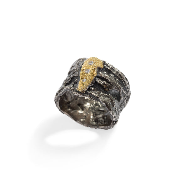 Raw You Black & Gold Ring by Emanuela Duca - A fusion of raw sophistication and modern elegance. Crafted from textured blackened sterling silver, it features three diamonds set against raw 18k yellow gold. Embodying contemporary style with a touch of edge, this piece elevates any ensemble with its unique allure.