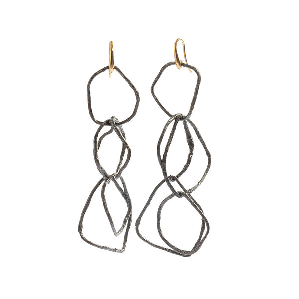 Raw You Long Dangling Earrings by Emanuela Duca - Introducing our "Raw You" long dangling earrings. Crafted in blackened sterling silver with 18k yellow gold ear hooks, they embody raw authenticity and individuality. Their captivating design boldly enhances any outfit with sophistication, allowing you to express your unique style effortlessly. Height: 3.5 inches.