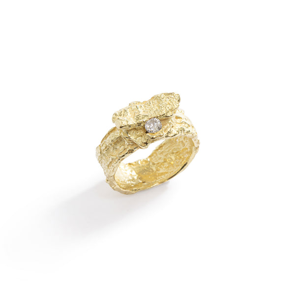 Raw You Gold Ring by Emanuela Duca - Presenting a fashion-forward statement: an 18k yellow gold ring boasting captivating texture and a stunning 3mm milky diamond. With a fashionable and edgy appeal, it also exudes a primal essence. This ring embodies a perfect balance of modernity and raw, primal allure, making it an essential addition to any bold and sophisticated ensemble.