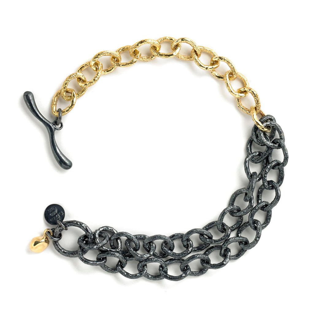 The InsideOut bracelet showcases a chain of textured 18k yellow gold contrasted by a double chain of blackened sterling silver. This combination offers a bit of a rock &amp; roll look while maintaining an air of elegance.  • 18k yellow gold, blackened sterling silver