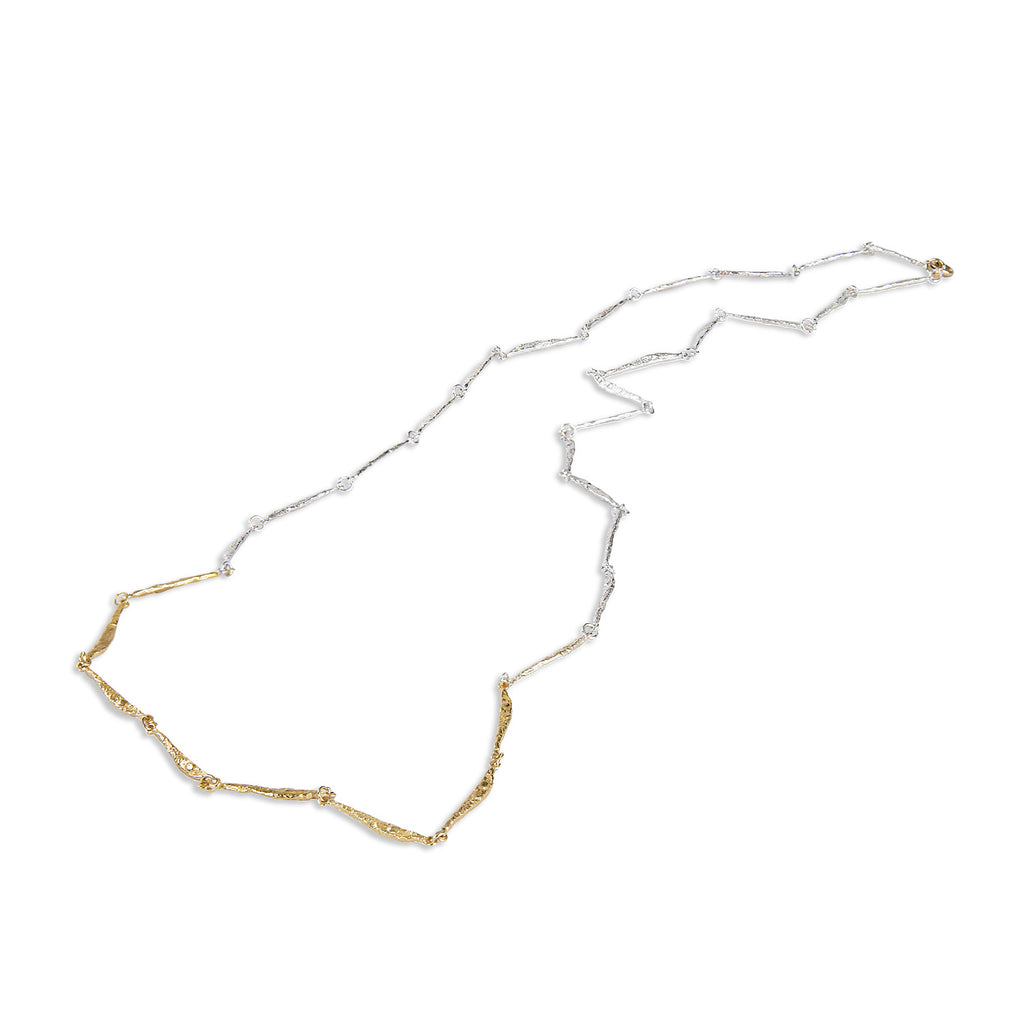 The Spark &amp; Soul necklace features a long and fluid design, combining blackened sterling silver and 18k yellow gold. This piece is an elegant and feminine statement.  • Blackened sterling silver, 18k yellow gold