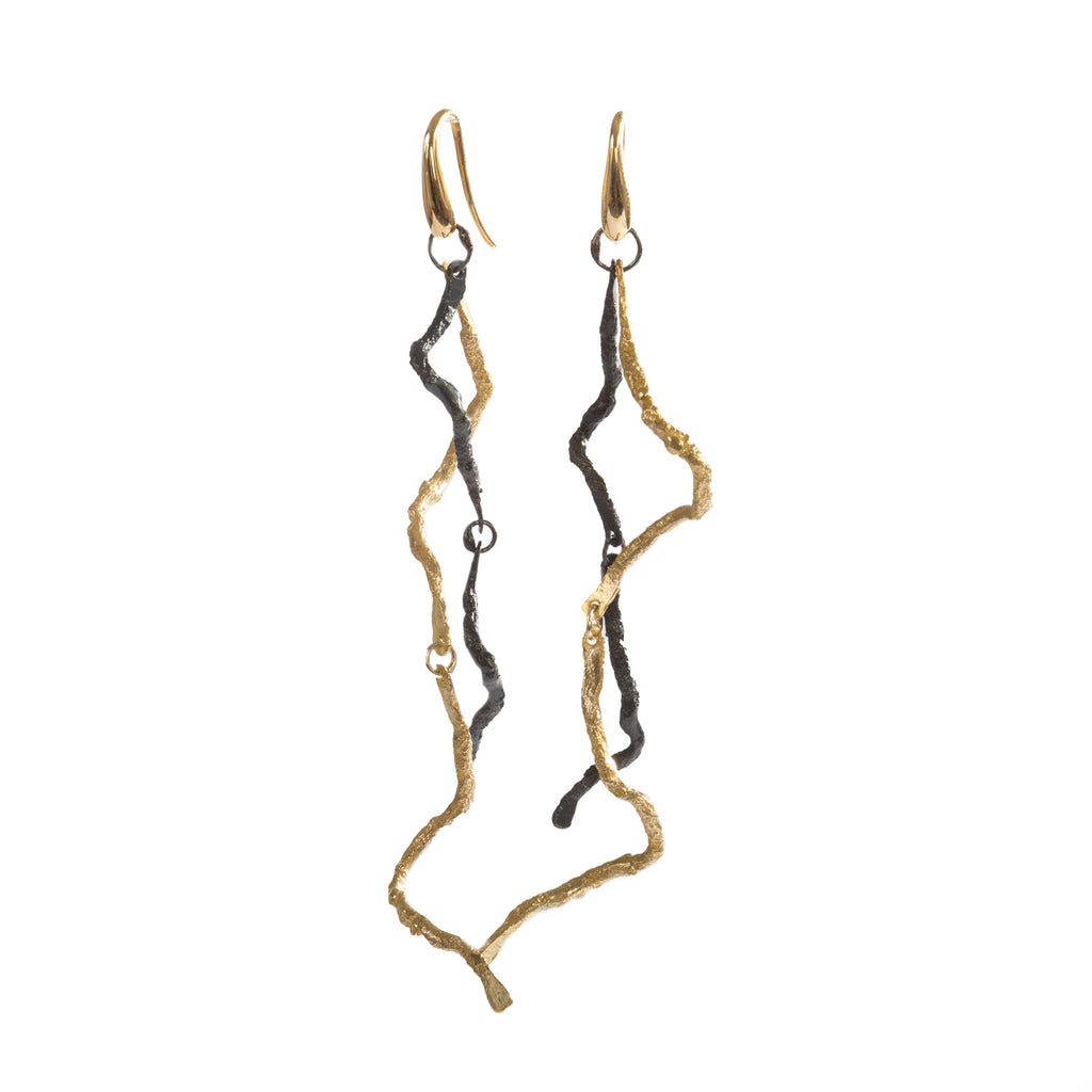 These long Respiro earrings in 18k yellow gold and blackened sterling silver are a unique piece for special occasions. This is art to wear, combining the warmth of gold with the boldness of blackened silver for a striking and elegant look.  • 18k yellow gold, blackened sterling silver  • Length: 3"