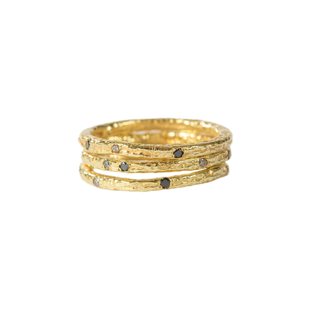 The Spark &amp; Soul stacking ring in 18k yellow gold, accented with small white and black diamonds, is a playful design perfect for everyday wear. It adds a spark to your day with its charming and versatile style.  • 18k yellow gold, diamonds 0.36 cts