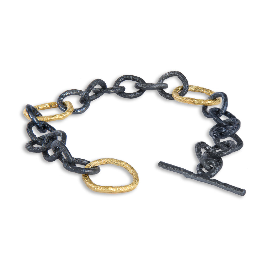 The Spark &amp; Soul links bracelet, crafted in 18k yellow gold and blackened sterling silver, celebrates the striking contrast and beauty of these two colors. Versatile enough for everyday wear yet elegant for special occasions, it embodies both style and sophistication.  • 18k yellow gold, blackened sterling silver