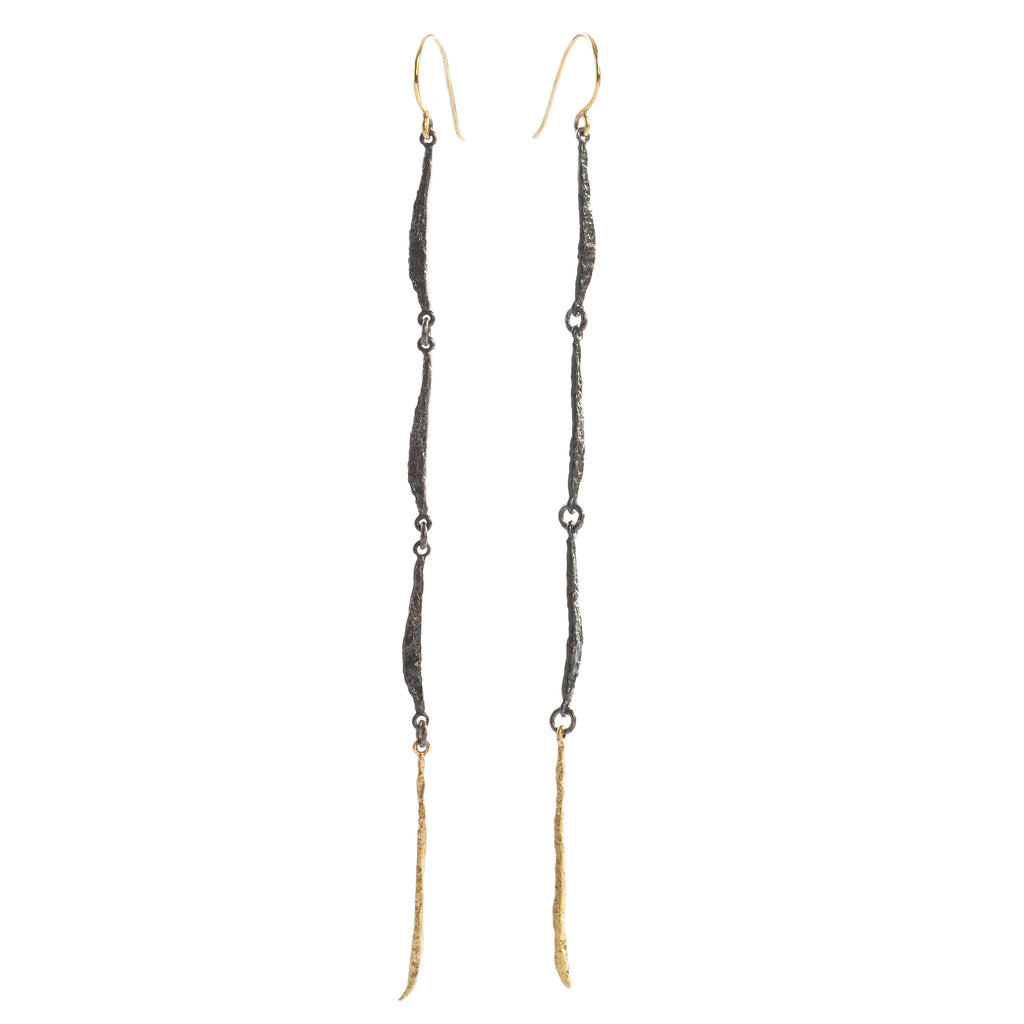 The Spark & Soul long earring features a fluid design, combining sterling silver and 18k yellow gold. This elegant piece makes a statement of femininity.  • Blacked sterling silver, 18k yellow gold  • Length: 3"