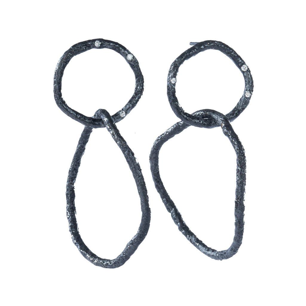 The Spark & Soul dangling earrings in blackened sterling silver showcase simplicity with a touch of earthy and contemporary flair. The top textured links are adorned with small diamonds, creating an effect reminiscent of a dark sky filled with stars.  • Blackened sterling silver, diamonds 0.09 cts  • Length: 2.25"