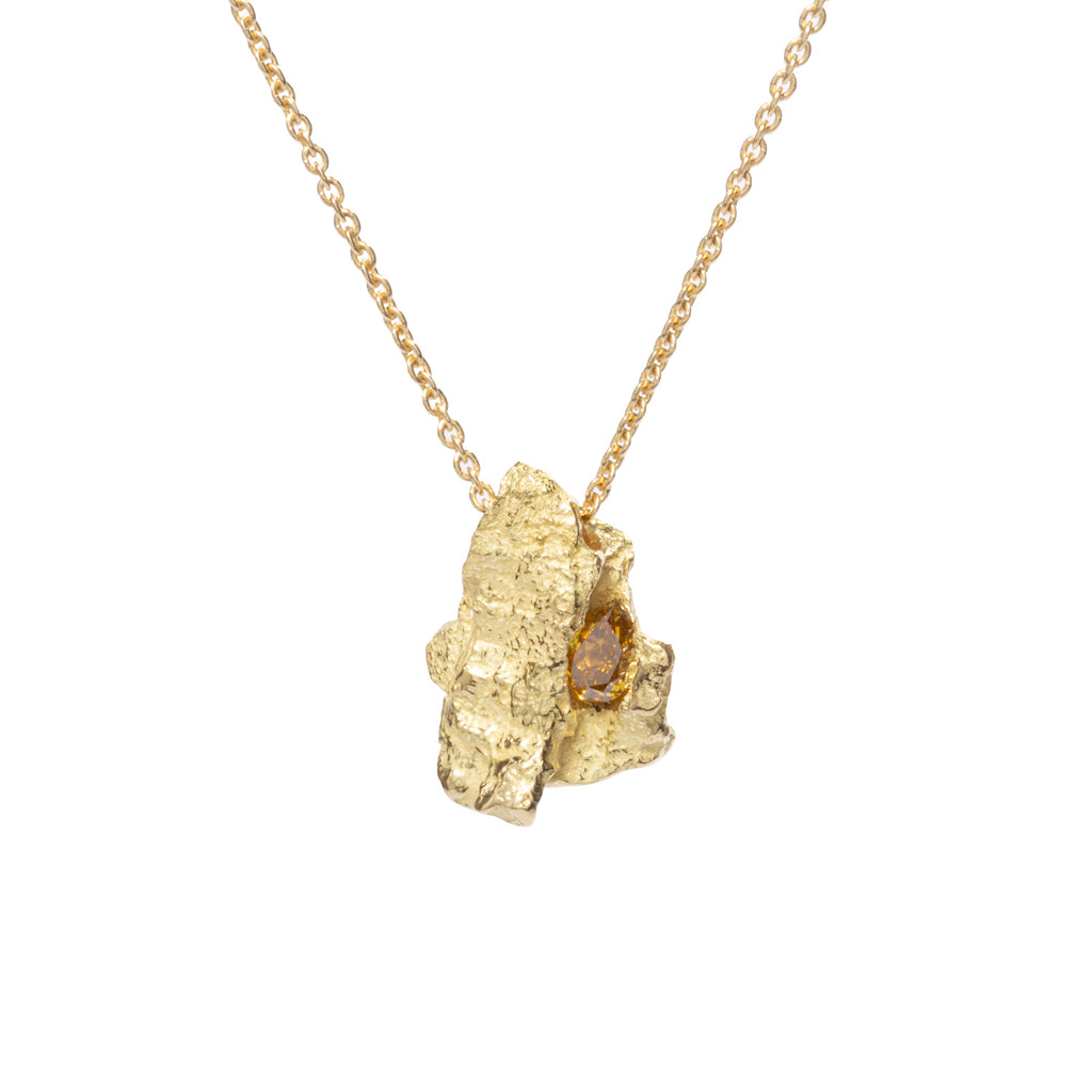 Raw You Pear Shape Cognac Diamond Necklace by Emanuela Duca - A textured pendant crafted from lustrous 18k yellow gold, showcasing a captivating pear-shaped cognac diamond. With its earthy yet contemporary aesthetic, this piece is a little sculpture to wear, effortlessly elevating any ensemble. One of a kind.