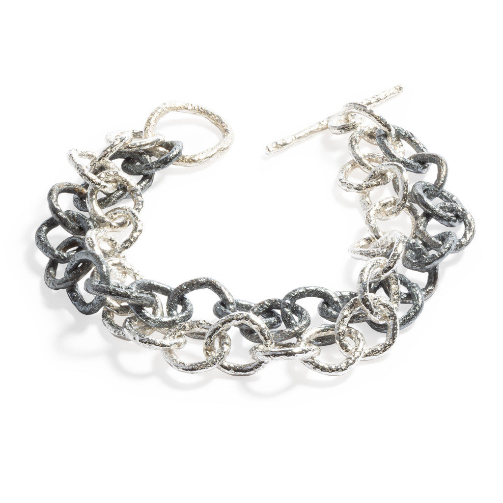 Good Vibes Black & White Bracelet by Emanuela Duca - A bold interplay of black and white textured sterling silver links. This captivating piece is defined by the stark contrast between the two lines of links, creating a visually stunning and versatile accessory.