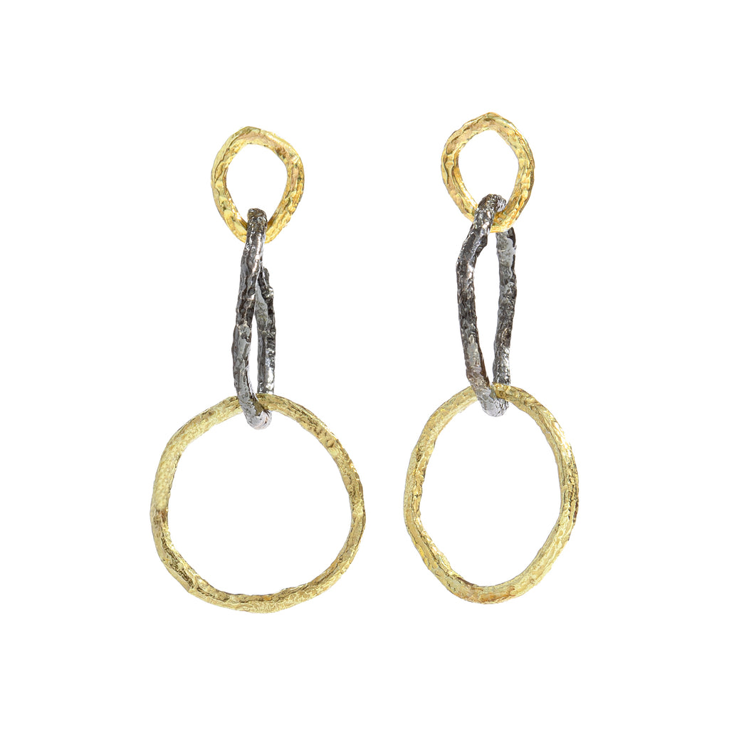 The Mystic Dangling Earrings by Emanuela Duca - The Mystic earrings, a fusion of 18k yellow gold and blackened sterling silver. Their combination of large and small textured links, along with contrasting metals, creates a captivating allure. Versatile and elegant, these earrings are perfect for everyday wear, adding a touch of sophistication to any ensemble. • 18k yellow gold; blackened sterling silver 