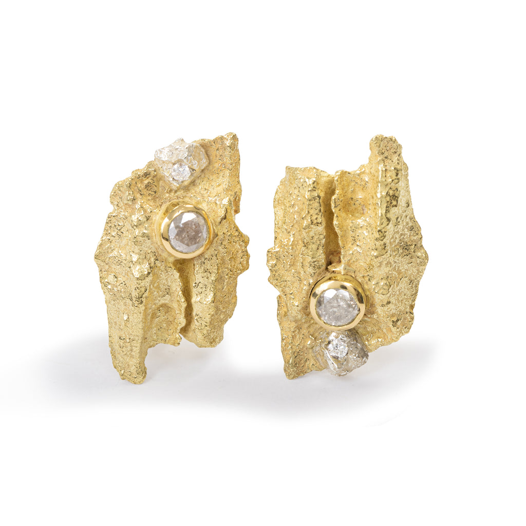 Raw You Gold Clips Earrings With Diamonds by Emanuela Duca  - Introducing our "Raw You" earrings crafted in textured 18k yellow gold, adorned with 2 white diamonds (2mm) and 2 milky diamonds (4mm). These earrings strike a balance between primitive allure and sophisticated elegance, offering a cool, distinct aesthetic. With clips and posts on the back, they ensure both style and practicality. Embrace their unique charm for a look that's effortlessly chic and undeniably you.