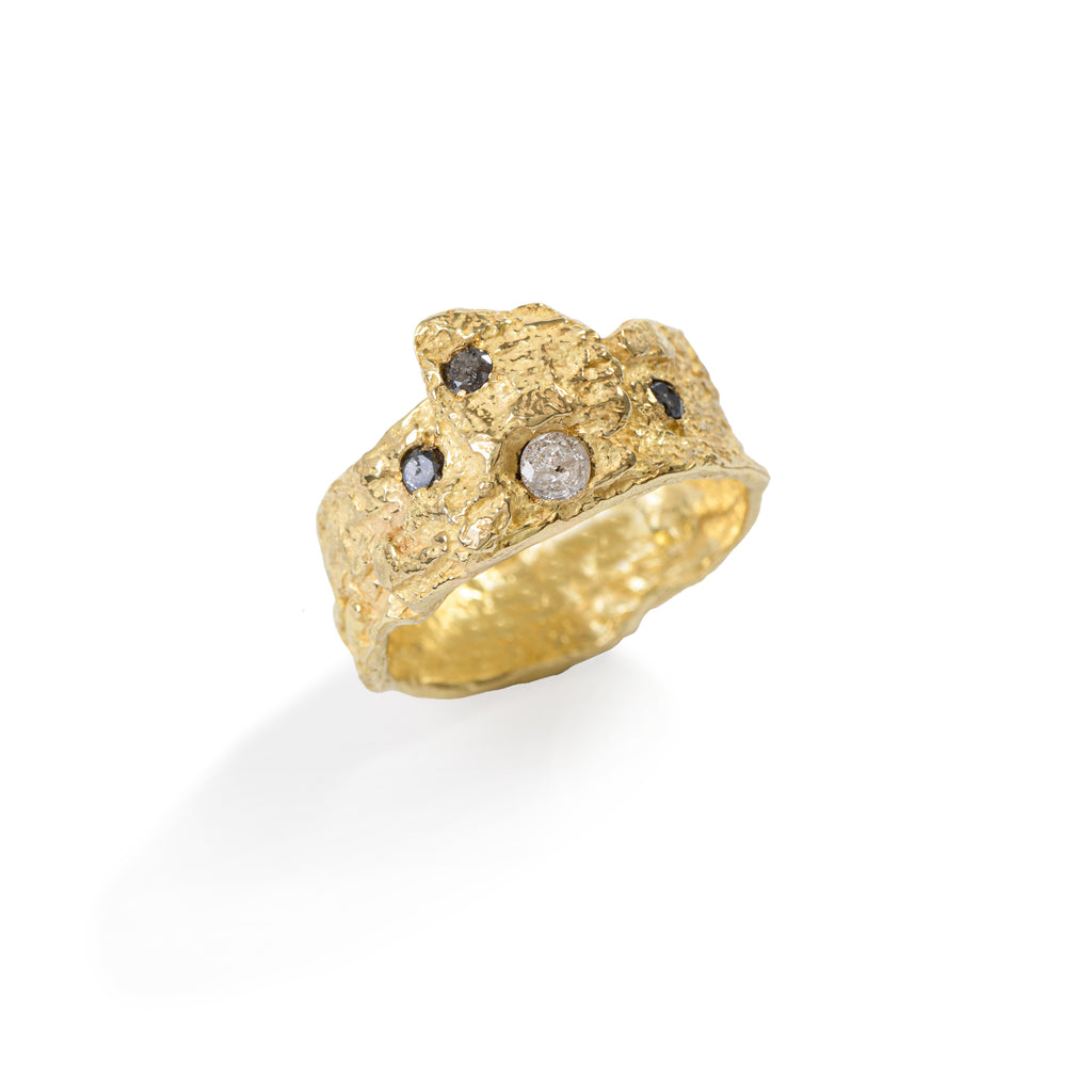 Raw You Gold & Diamonds Ring by Emanuela Duca - Introducing a fusion of raw sophistication and modern elegance. Crafted from highly textured 18k yellow gold, this piece features 1 milky diamond (3mm) and 3 black/grey diamonds (2mm). Embodying contemporary style with a touch of ancient allure, this ring elevates any ensemble with its unique charm.