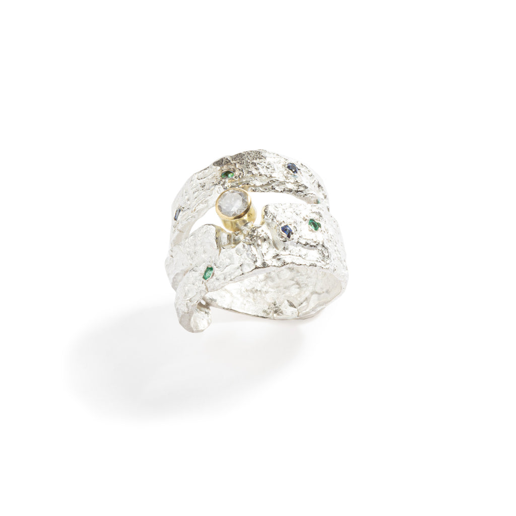 Good Vibes Silver Ring with Diamonds by Emanuela Duca - Crafted in textured sterling silver, it features a milky diamond (4mm) set in a gold bezel, accompanied by three blue sapphires (1.7mm) and three emeralds (1.7mm). Radiating with Good Vibes and positivity, this ring is a statement piece that adds elegance and charm to any occasion.