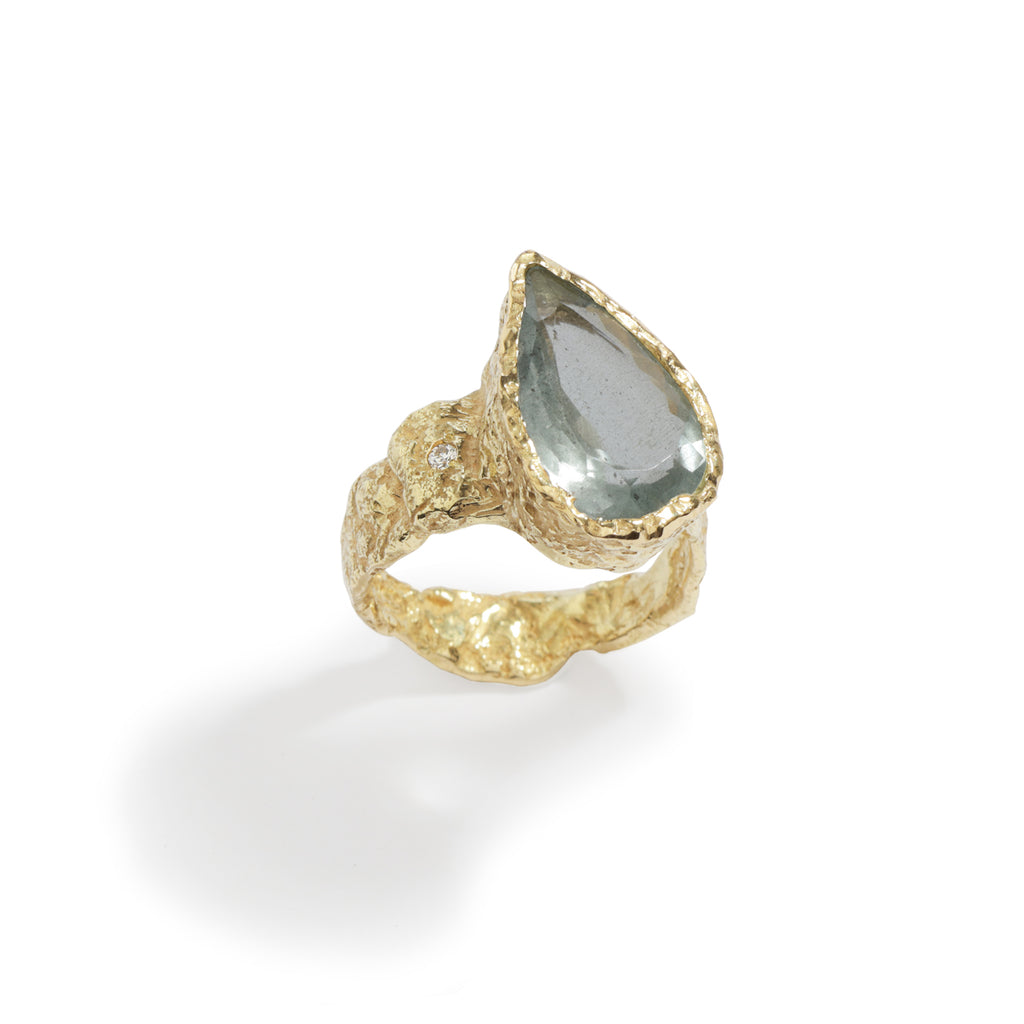 Good Vibes Aquamarine Ring by Emanuela Duca - Crafted in textured 18K yellow gold, it showcases a beautiful off-center aquamarine stone accompanied by a petite diamond. Radiating with Good Vibes and positivity, this ring is a statement piece that adds elegance and a light blue pop of color, embodying the energy of spring and summer with a touch of flare.