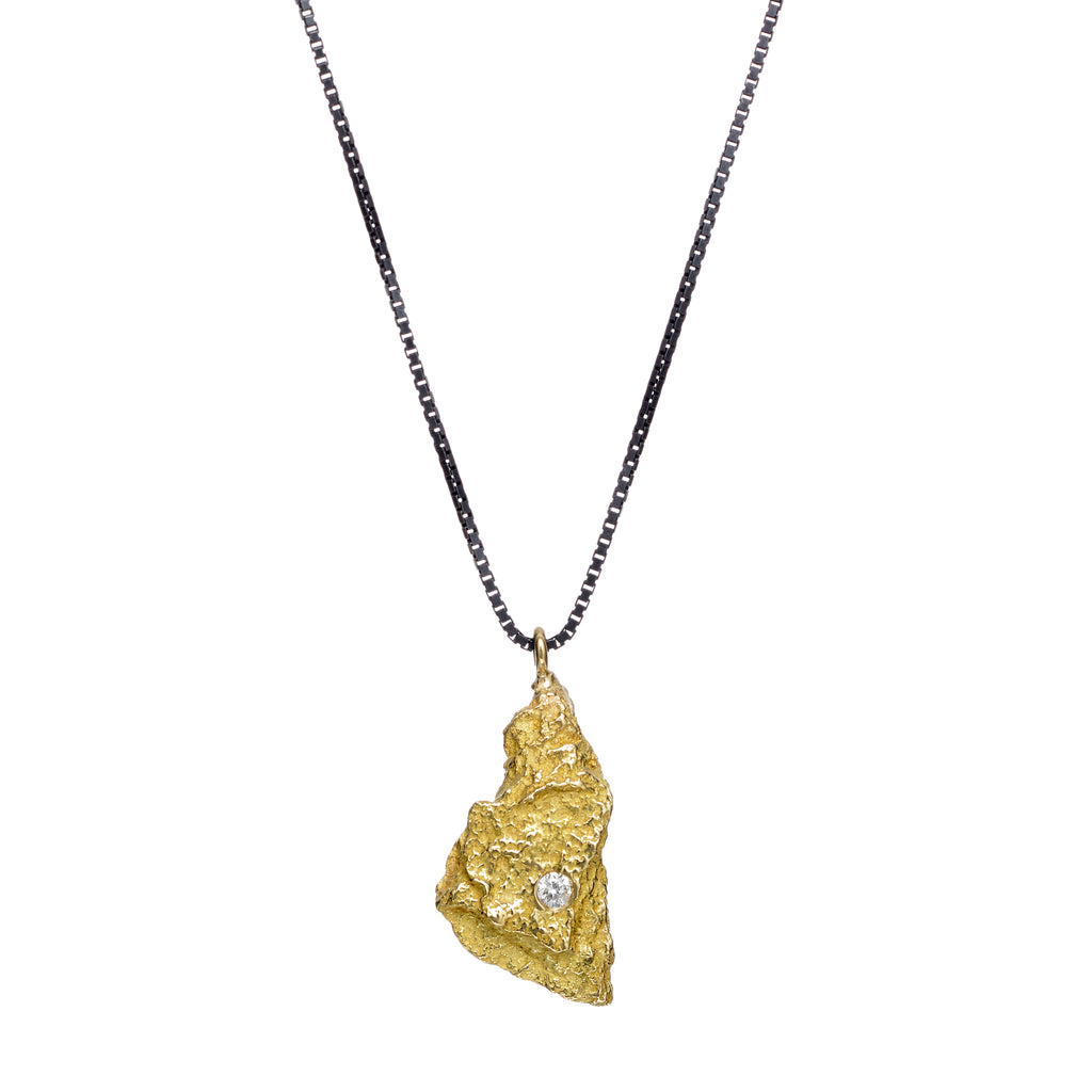 The Burst small pendant in 18k yellow gold is adorned with a delicate accent of a small diamond, suspended elegantly from a sleek blackened sterling silver chain.  • 18k yellow gold, blackened sterling silver, diamond 0.026 cts  • Chain length: 18"&nbsp;