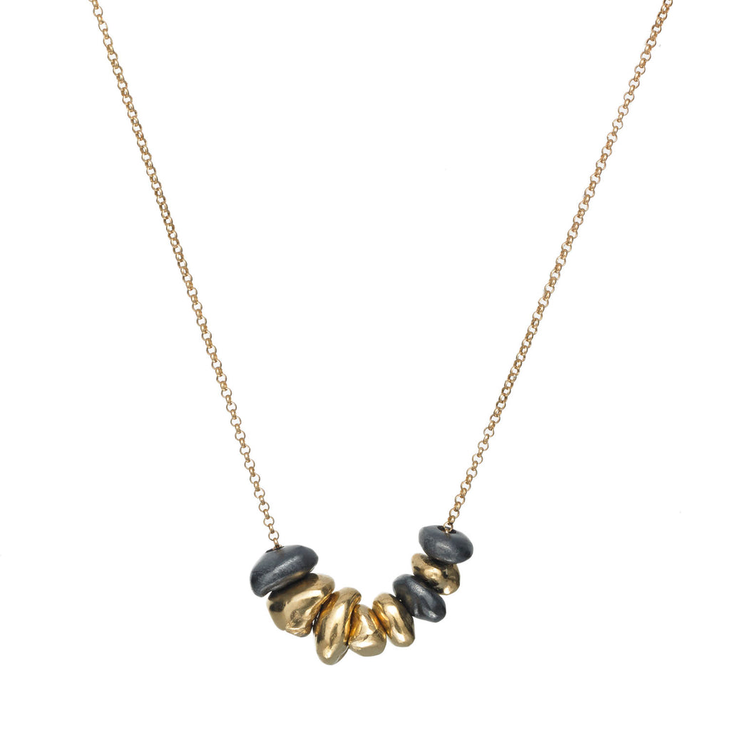 The InsideOut necklace features shiny elements in 18k yellow gold and blackened sterling silver, all held by an 18k yellow gold chain. Its fluid design makes it perfect for everyday wear.  • 18k yellow gold, blackened sterling silver  • Chain length: 18"